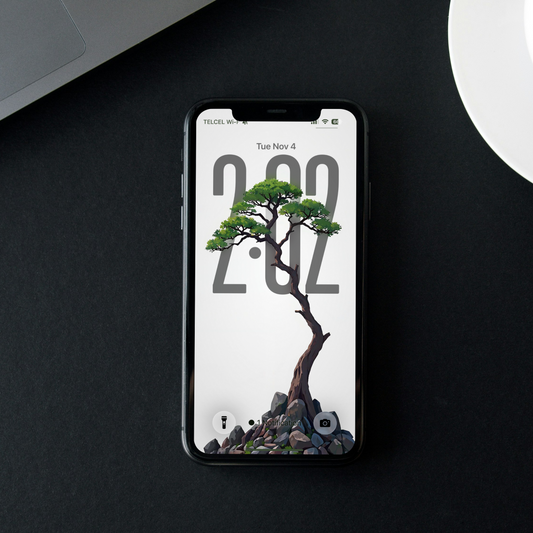 Front-facing phone displaying a slender bonsai tree with green foliage growing from rocks on white.