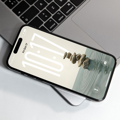 Smartphone with a nature-themed app displayed on a laptop