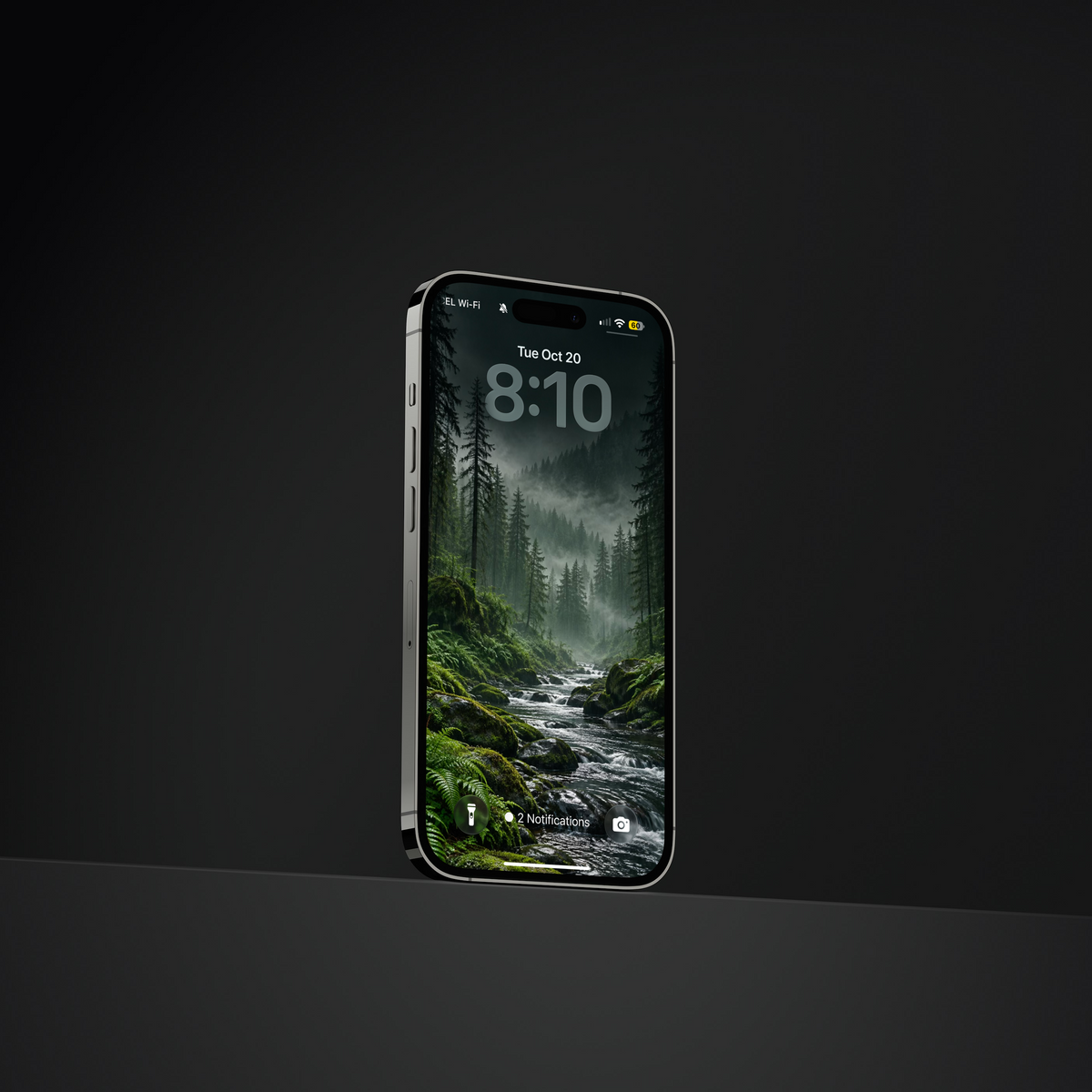 Angled phone displaying a rocky stream running through a misty green conifer forest.