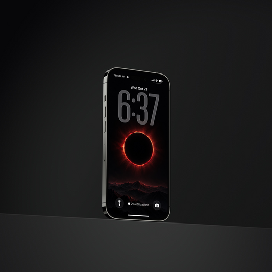 A black smartphone shown upright against a dark studio background, with its screen on displaying a red eclipse-style wallpaper and the time 6:37.