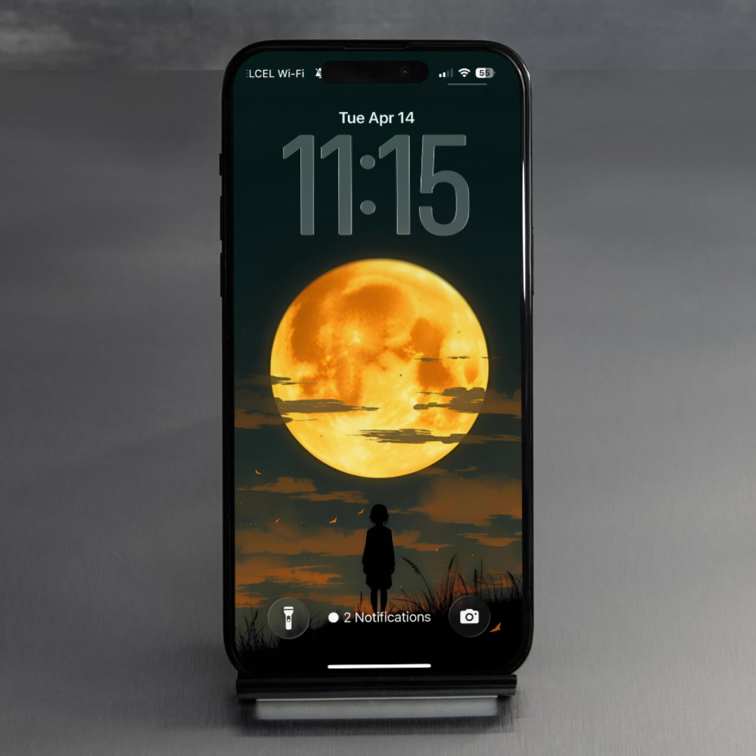 Phone with a sunset and silhouette design on the screen against a dark background