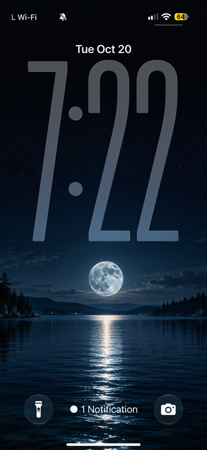 Lock screen preview showing a full moon reflected in a dark blue lake between forested shores.