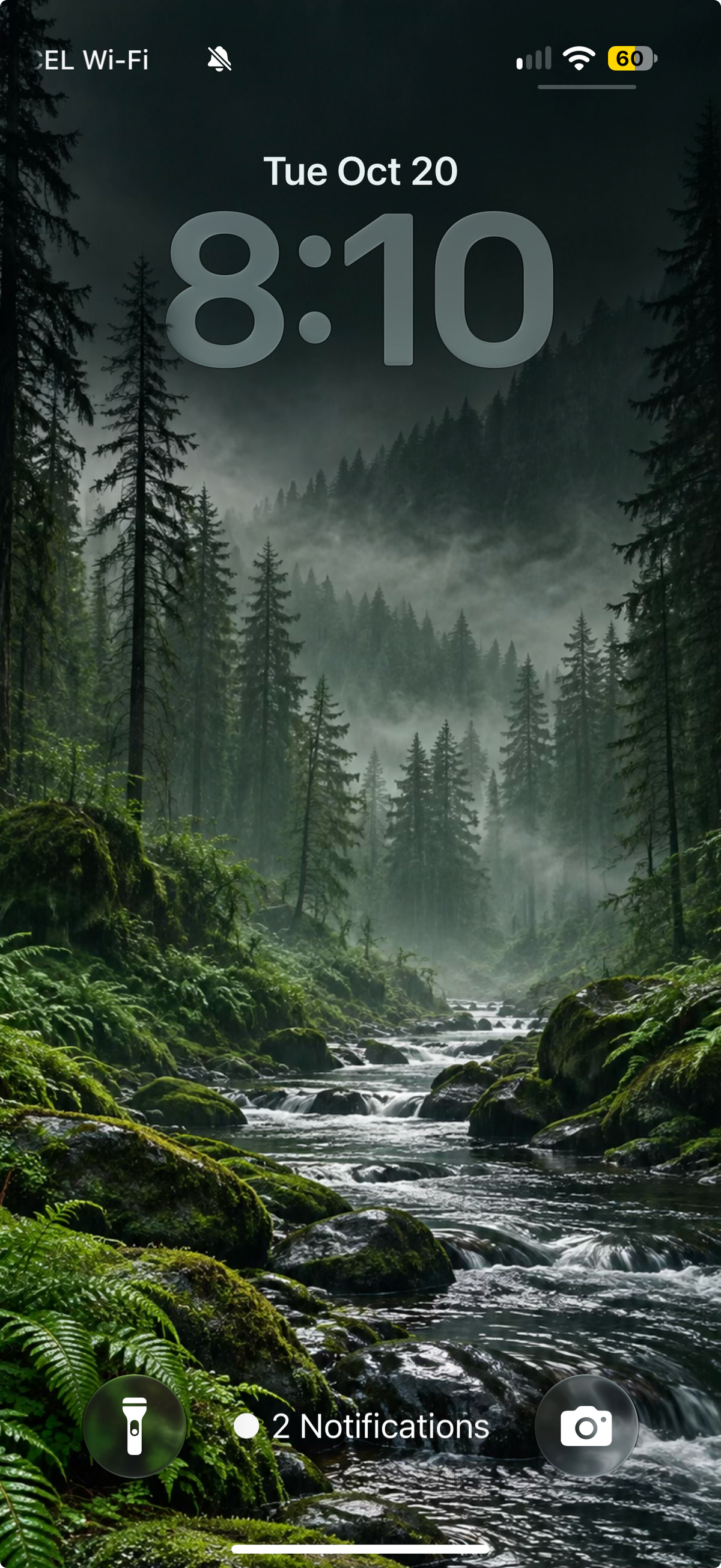 Lock screen preview showing a rocky stream running through a misty green conifer forest.