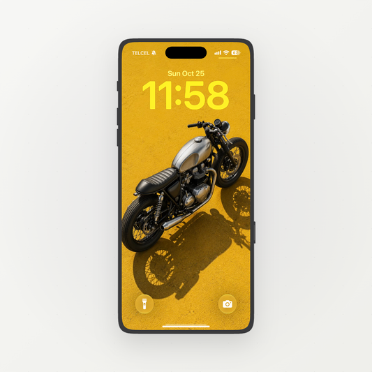 Front-facing phone showing a black and silver cafe racer motorcycle on mustard yellow ground.