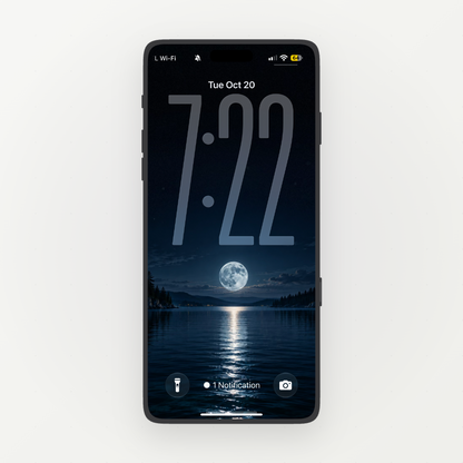 Front-facing phone displaying a full moon reflected in a dark blue lake between forested shores.