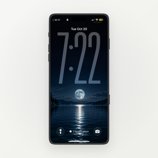 Front-facing phone displaying a full moon reflected in a dark blue lake between forested shores.