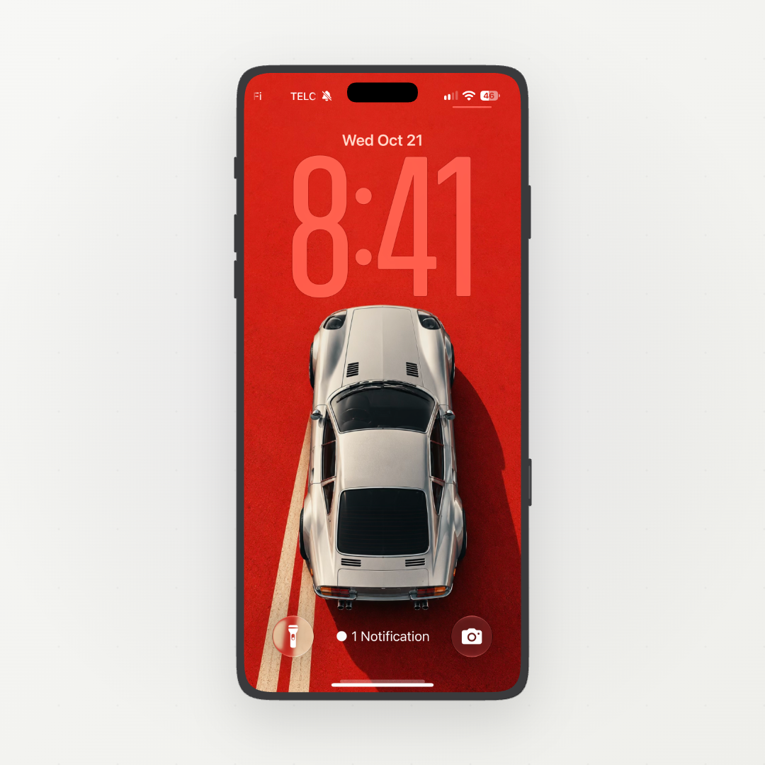 Phone displaying Retro Drive, a silver classic sports car viewed from above on a red background.